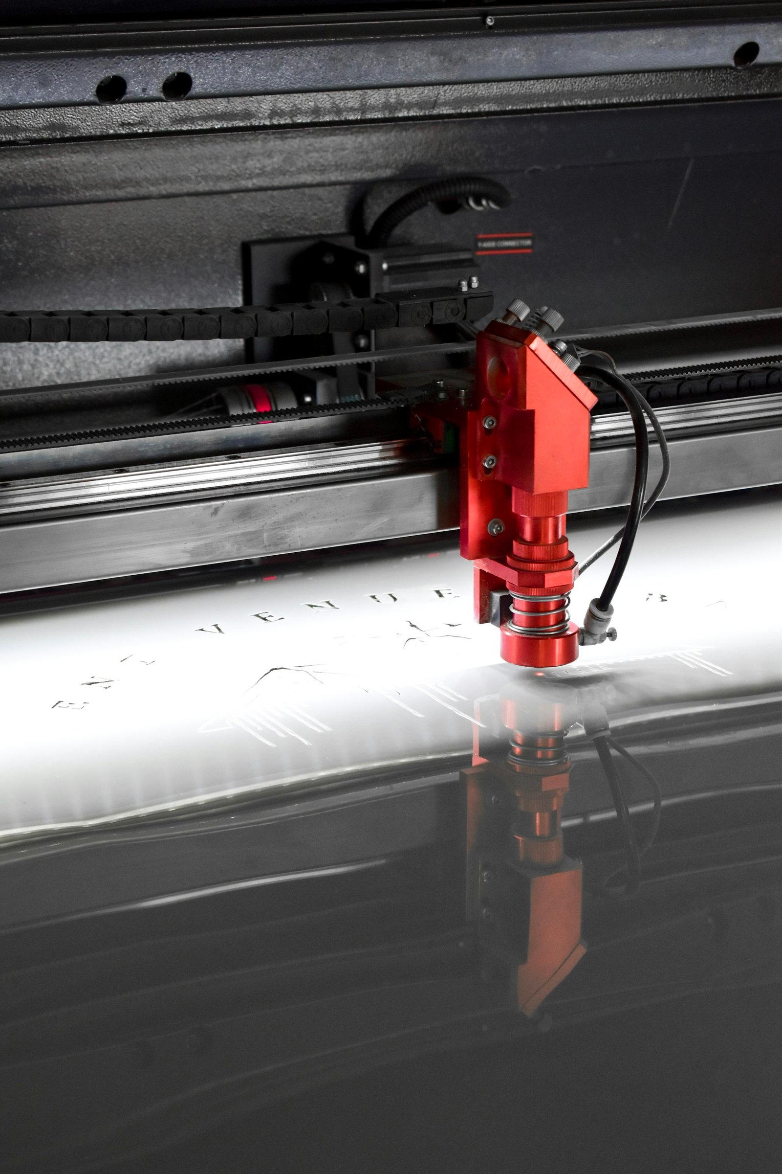 Laser engraving a custom design in the Ortex Industries workshop